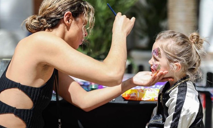 Festival glitter face painting at Trafford Palazzo