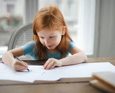 Little girl doing school work from home